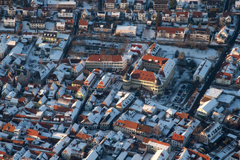 Wintry snowy townscape with streets and houses of the residential areas in Bad Bergzabern in the state Rhineland-Palatinate from above