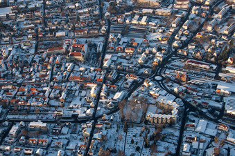 Wintry snowy townscape with streets and houses of the residential areas in Bad Bergzabern in the state Rhineland-Palatinate out of the air