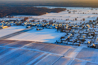Raiffeisenstraße in winter with snow in Freckenfeld in the state Rhineland-Palatinate, Germany