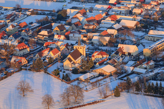 Aerial view of Catholic church in winter with snow in Minfeld in the state Rhineland-Palatinate, Germany
