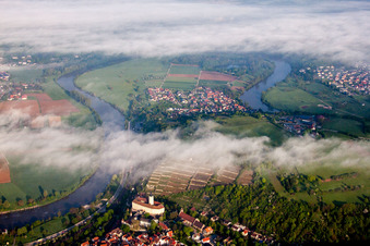 Aerial view of Castle of Schloss Horneck between clouds in Gundelsheim in the state Baden-Wurttemberg