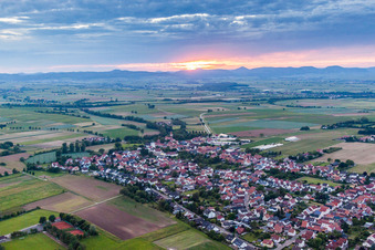 Village - view at sunset on the edge of agricultural fields and farmland in Minfeld in the state Rhineland-Palatinate, Germany