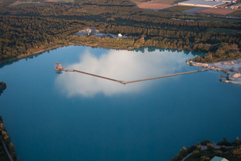 Schertle Lake with floating conveyor belt to the gravel dredger in Bietigheim in the state Baden-Wuerttemberg, Germany