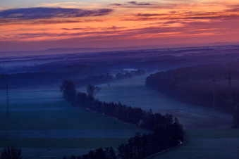Aerial view of Otterbach lowlands in the morning mist at sunrise in Kandel in the state Rhineland-Palatinate, Germany