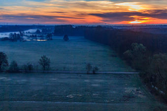 Otterbach lowlands in the morning mist at sunrise in Minfeld in the state Rhineland-Palatinate, Germany from above