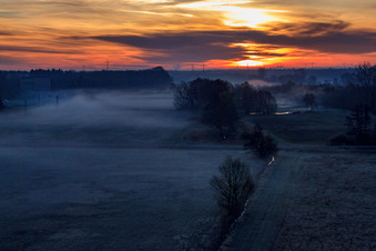 Drone recording of Otterbach lowlands in the morning mist at sunrise in Minfeld in the state Rhineland-Palatinate, Germany
