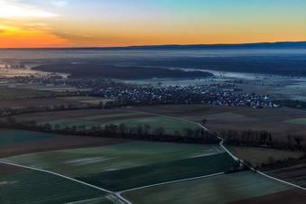 Village view in the morning mist from the northwest in Freckenfeld in the state Rhineland-Palatinate, Germany
