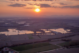 Colorful sunset over the countryside in Neupotz in the state Rhineland-Palatinate dyes the sky purple and orange