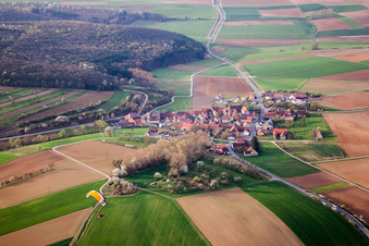 Aerial view of Village - view on the edge of agricultural fields and farmland in Junkershausen in the state Bavaria, Germany