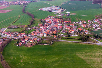 Aerial view of Village - view on the edge of agricultural fields and farmland in Simmershausen in the state Thuringia, Germany