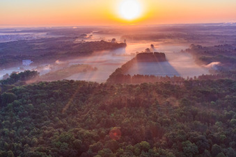 Oblique view of Sunrise over the Otterbach lowlands in the morning mist in Minfeld in the state Rhineland-Palatinate, Germany