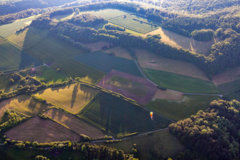 Paragliding over fields and forests in Pegestorf in the state Lower Saxony, Germany