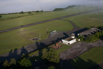 Runway with tarmac terrain of airfield Hoexter-Holzminden with morning mist in the district Brenkhausen in Hoexter in the state North Rhine-Westphalia, Germany
