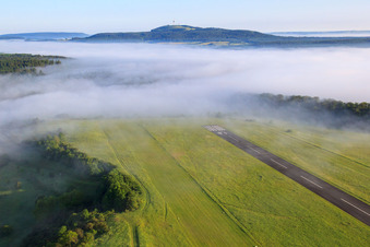 Runway of the Höxter-Holzminden (EDVI) airfield in the early morning fog in the district Albaxen in Höxter in the state North Rhine-Westphalia, Germany