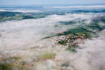 Wind turbine windmills in morning mist on a field in the district Fuerstenau in Hoexter in the state North Rhine-Westphalia