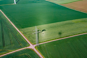 Aerial photograpy of Shadow of paraglider next to high-voltage pylon in the district Bredenborn in Marienmünster in the state North Rhine-Westphalia, Germany
