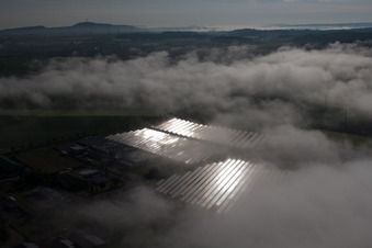 Aerial view of Weather-related panel rows of the photovoltaic plant of the solar park or solar power plant in the district Bredenborn in Marienmuenster in the state North Rhine-Westphalia