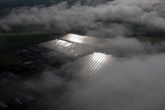 Aerial photograpy of Weather-related panel rows of the photovoltaic plant of the solar park or solar power plant in the district Bredenborn in Marienmuenster in the state North Rhine-Westphalia