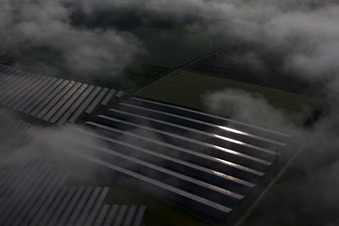 Weather-related panel rows of the photovoltaic plant of the solar park or solar power plant in the district Bredenborn in Marienmuenster in the state North Rhine-Westphalia from above