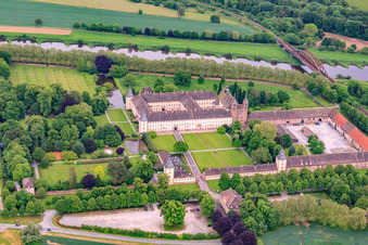 Aerial view of UNESCO World Heritage Site Corvey Castle on the banks of the Weser with castle restaurant, Weser-Aktivhotel-Corvey and Remtergarten State Garden Show Höxter in Höxter in the state North Rhine-Westphalia, Germany