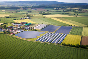 Aerial view of Panel rows of photovoltaic and solar farm or solar power plant in the district Bredenborn in Marienmuenster in the state North Rhine-Westphalia