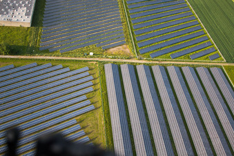 Oblique view of Panel rows of photovoltaic and solar farm or solar power plant in the district Bredenborn in Marienmuenster in the state North Rhine-Westphalia