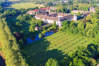 Oblique view of UNESCO World Heritage Site Corvey Castle on the banks of the Weser with Remter Garden State Garden Show Höxter in Höxter in the state North Rhine-Westphalia, Germany