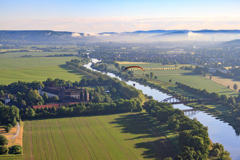 Aerial photograpy of Corvey Castle/Monastery (UNESCO World Heritage Site) on the river - bridge structure over the Weser in Höxter in the state North Rhine-Westphalia, Germany