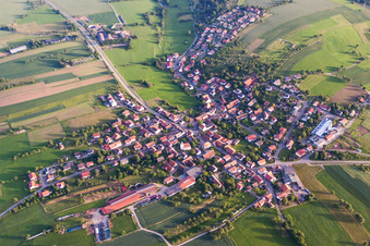 Aerial view of Village - view on the edge of agricultural fields and farmland in Schollbrunn in the state Baden-Wurttemberg, Germany