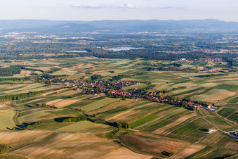 Aerial view of Village - view on the edge of agricultural fields and farmland in Wintzenbach in Grand Est, France