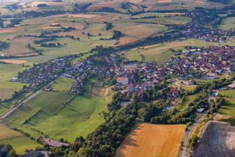 Village - view on the edge of agricultural fields and farmland in Oberleichtersbach in the state Bavaria, Germany