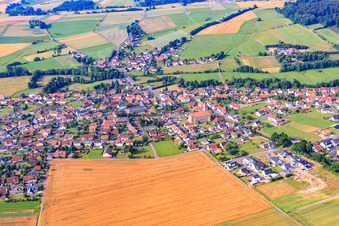 Town center with Catholic Church of the Assumption of Mary in the district Rommerz in Neuhof in the state Hesse, Germany