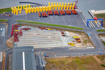 Aerial view of Port facilities on the sea coast of Cuxport GmbH for offshore wind turbines in Cuxhaven in the state Lower Saxony, Germany