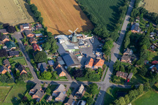 Historic windmill on a farm homestead of Hass Landhandel on the edge of cultivated fields in Suederhastedt in the state Schleswig-Holstein, Germany