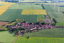 Wind turbines of a wind power plant on agricultural land and fields on the edge of the settlement area of the village in Hochheim in the state Thuringia, Germany