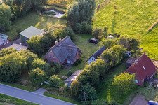 Schülpersieler Street in the district Schülperweide in Wesselburenerkoog in the state Schleswig Holstein, Germany from the drone perspective