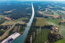 High voltage power lines crossing the channel flow and river banks of the waterway shipping Wesel-Datteln-channel in Marl in the state North Rhine-Westphalia, Germany