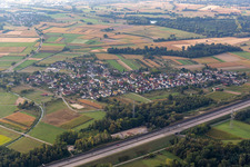 Agricultural land and field borders surround the settlement area of the village behind the motorway A5 in Balzhofen in the state Baden-Wuerttemberg, Germany