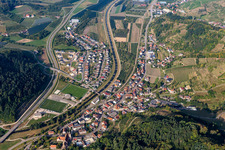 Location view of the streets and houses of residential areas in the valley landscape surrounded by mountains in Lautenbach in the state Baden-Wuerttemberg, Germany