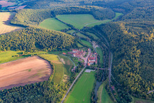 Aerial photograpy of Complex of buildings of the monastery Bronnbach with garden and Church Mariae Himmelfahrt in Wertheim in the state Baden-Wurttemberg, Germany