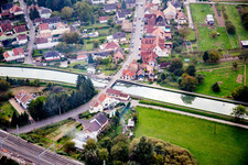 Aerial view of River - bridge construction crossing the Muehlbach in Vendenheim in Grand Est, France