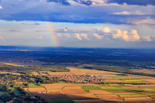 Rainbow over the village from the west in Steinweiler in the state Rhineland-Palatinate, Germany