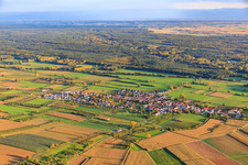 Village view between autumnal fields and meadows from the north in Schweighofen in the state Rhineland-Palatinate, Germany