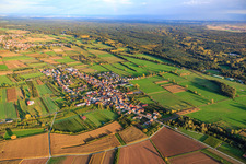 Aerial view of Village overview between autumnal fields and meadows with St. Laurentius Church from the northwest in Schweighofen in the state Rhineland-Palatinate, Germany