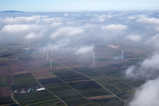 Wind energy installations embedded under a cloud layer on a field near Worms in the state Rhineland-Palatinate