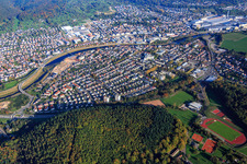Oblique view of View of the town from both sides of the Murg river from the southwest in front of the Daimler Truck AG factory premises in Gaggenau in the state Baden-Wuerttemberg, Germany