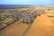 Oblique view of Village overview in winter on the B427 from the east in Minfeld in the state Rhineland-Palatinate, Germany