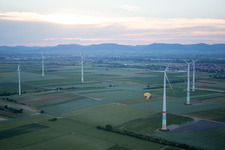 Aerial view of Hot air balloon between wind turbines in Offenbach an der Queich in the state Rhineland-Palatinate, Germany