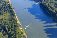 Water scooter vs. paraglider in or over the Rhine in the district Leopoldshafen in Eggenstein-Leopoldshafen in the state Baden-Wuerttemberg, Germany