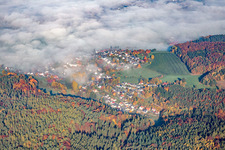 View of the town under morning mist in the district Erlenbach in Erbach in the state Hesse, Germany